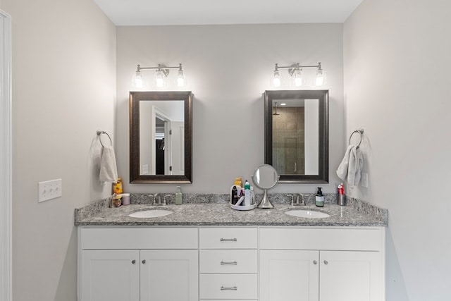 bathroom with a shower with door and vanity