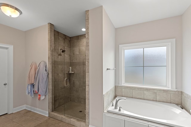 bathroom featuring tile patterned flooring and independent shower and bath