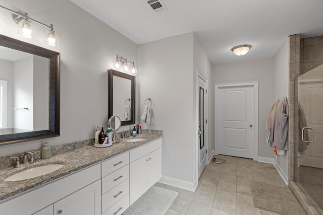 bathroom with an enclosed shower, tile patterned floors, and vanity