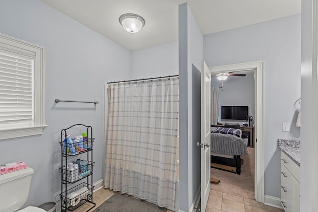 full bathroom with toilet, tile patterned floors, shower / tub combo with curtain, and vanity