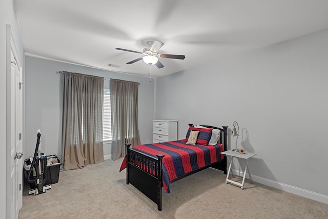 bedroom featuring ceiling fan and light carpet