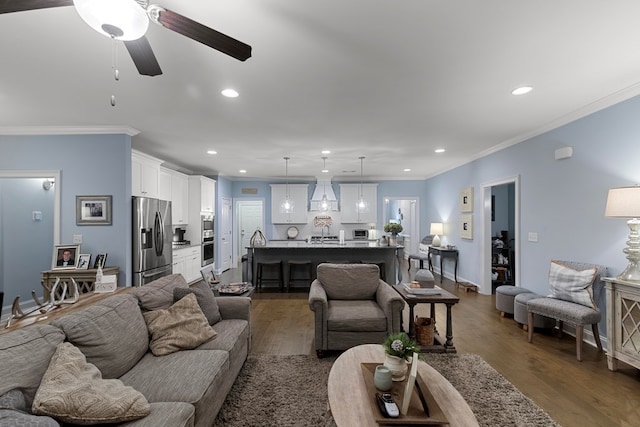 living room with ornamental molding, ceiling fan, and dark hardwood / wood-style floors