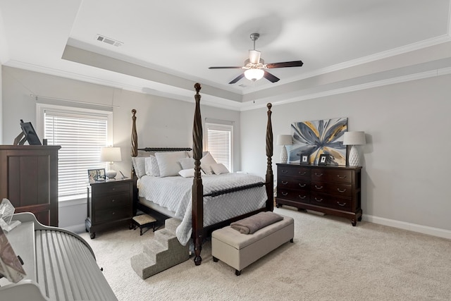 bedroom featuring ceiling fan, crown molding, and a raised ceiling