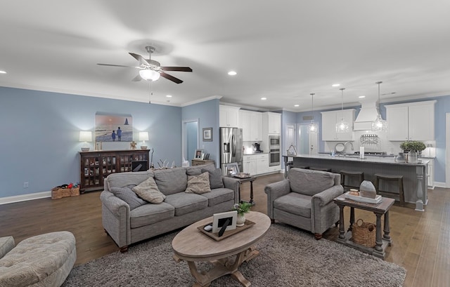 living room with ornamental molding, ceiling fan, and dark wood-type flooring