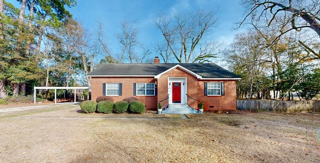 view of front of home with a carport and a front yard