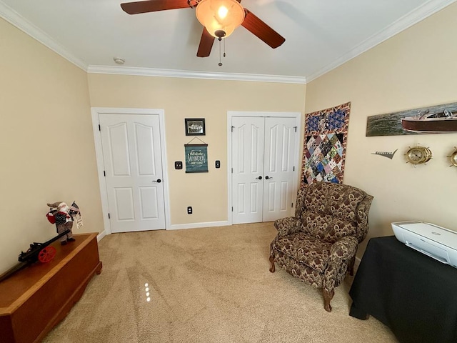 living area featuring carpet, ceiling fan, and ornamental molding