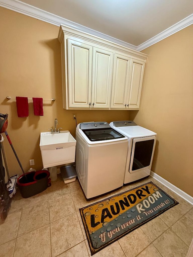 laundry room featuring sink, cabinets, independent washer and dryer, light tile patterned floors, and ornamental molding