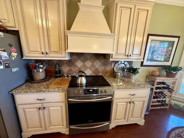 kitchen featuring light stone countertops, appliances with stainless steel finishes, ornamental molding, custom exhaust hood, and dark hardwood / wood-style floors