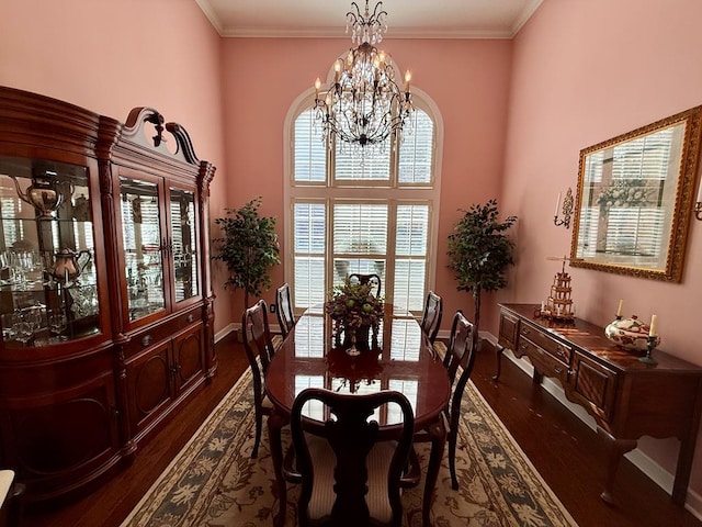 dining room featuring a chandelier, dark hardwood / wood-style floors, and crown molding