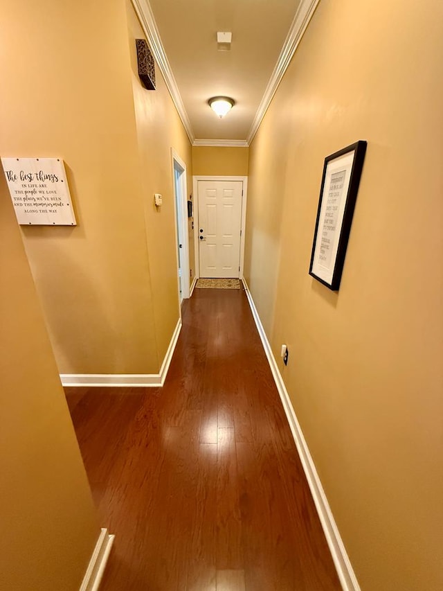 hall with hardwood / wood-style flooring and ornamental molding