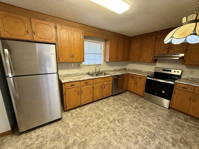 kitchen with sink, stainless steel appliances, and a textured ceiling