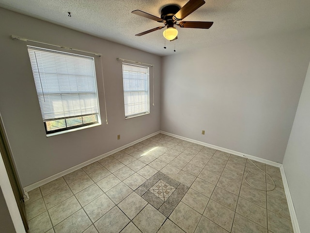 tiled spare room featuring ceiling fan and a textured ceiling