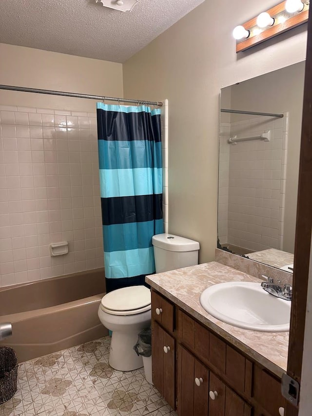 bathroom with shower / bathtub combination with curtain, toilet, vanity, and a textured ceiling