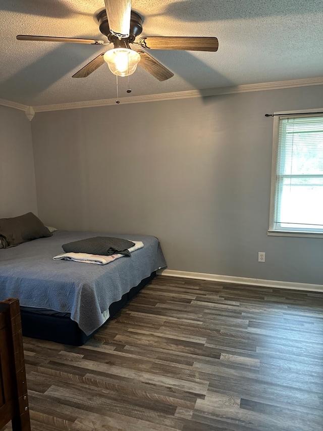 bedroom with a textured ceiling, dark wood-style flooring, and crown molding