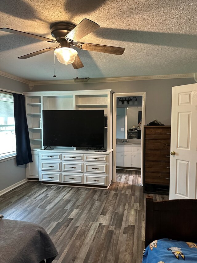 bedroom featuring dark wood finished floors, crown molding, ceiling fan, and a textured ceiling