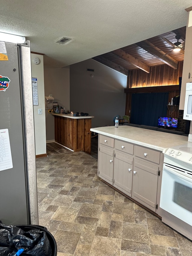 kitchen featuring tasteful backsplash, visible vents, stone finish flooring, light countertops, and white appliances