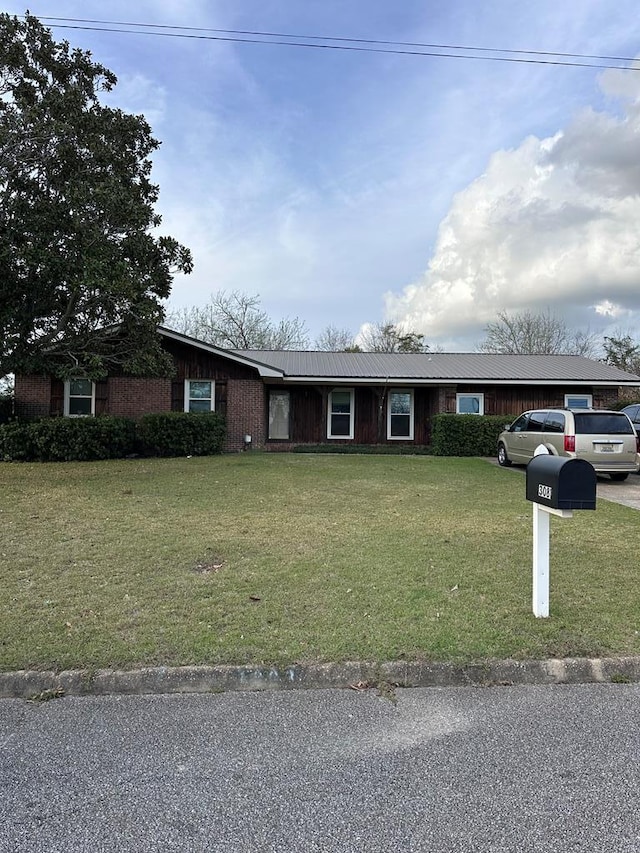 single story home with a front lawn, driveway, and metal roof