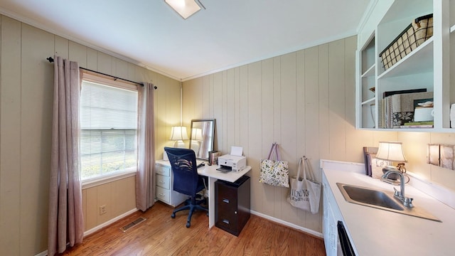 514 S Main St, Headland, AL 36345 - home office featuring ornamental molding, light wood-style flooring, a sink, and baseboards