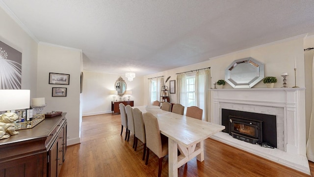 514 S Main St, Headland, AL 36345 - dining room featuring light wood-style floors, baseboards, crown molding, and a textured ceiling