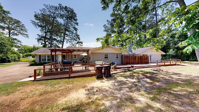 514 S Main St, Headland, AL 36345 - rear view of property featuring a deck, a pergola, and a chimney