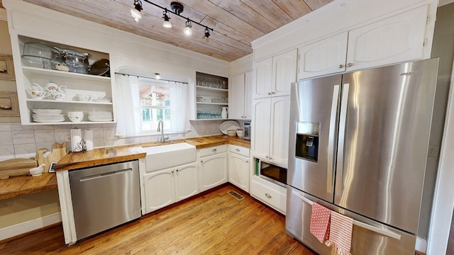 514 S Main St, Headland, AL 36345 - kitchen featuring stainless steel appliances, open shelves, wood counters, a sink, and white cabinets