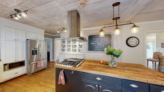 514 S Main St, Headland, AL 36345 - kitchen with stainless steel appliances, island range hood, blue cabinets, light wood finished floors, and white cabinets
