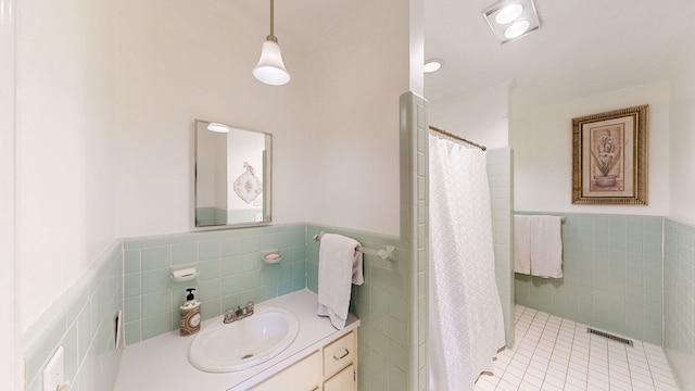 514 S Main St, Headland, AL 36345 - full bath featuring tile walls, a wainscoted wall, vanity, tile patterned floors, and curtained shower