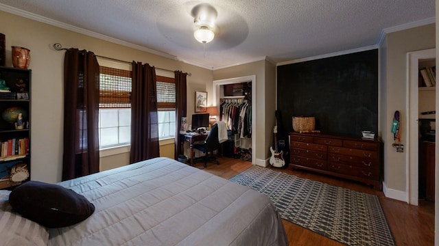 514 S Main St, Headland, AL 36345 - bedroom featuring ornamental molding, wood finished floors, a closet, a textured ceiling, and ceiling fan
