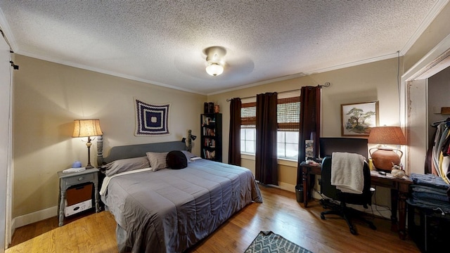 514 S Main St, Headland, AL 36345 - bedroom featuring a textured ceiling, wood finished floors, ornamental molding, baseboards, and an office area