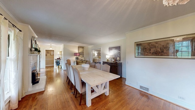 514 S Main St, Headland, AL 36345 - dining area featuring ornamental molding, wood finished floors, baseboards, and a fireplace with raised hearth