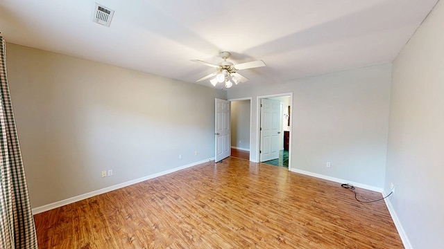 412 Darlington Cir, Dothan, AL 36301 - unfurnished bedroom featuring baseboards, wood finished floors, a ceiling fan, and connected bathroom