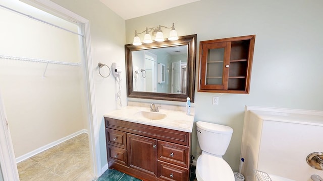 412 Darlington Cir, Dothan, AL 36301 - bathroom featuring vanity, a walk in closet, and toilet