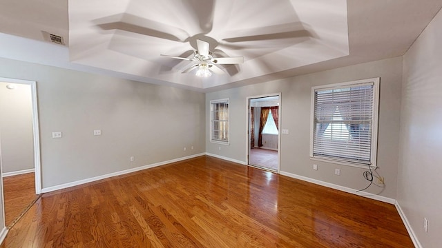 412 Darlington Cir, Dothan, AL 36301 - empty room featuring a tray ceiling, a ceiling fan, wood finished floors, and baseboards