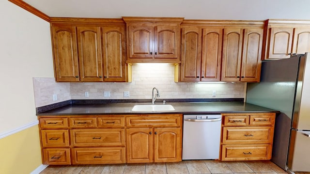 412 Darlington Cir, Dothan, AL 36301 - kitchen with appliances with stainless steel finishes, a sink, dark countertops, and tasteful backsplash