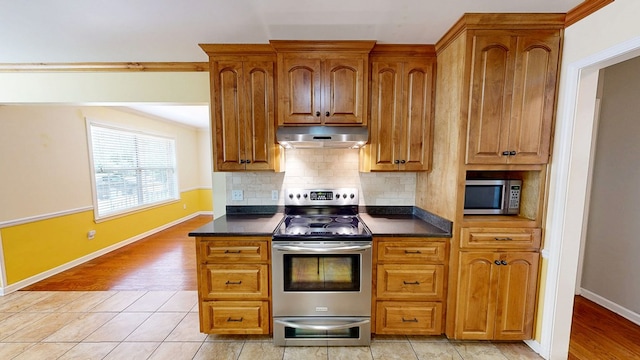 412 Darlington Cir, Dothan, AL 36301 - kitchen featuring under cabinet range hood, stainless steel appliances, dark countertops, and decorative backsplash