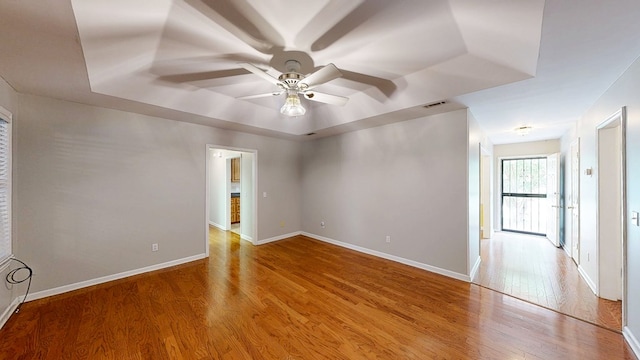 412 Darlington Cir, Dothan, AL 36301 - empty room featuring a raised ceiling, ceiling fan, wood finished floors, and baseboards