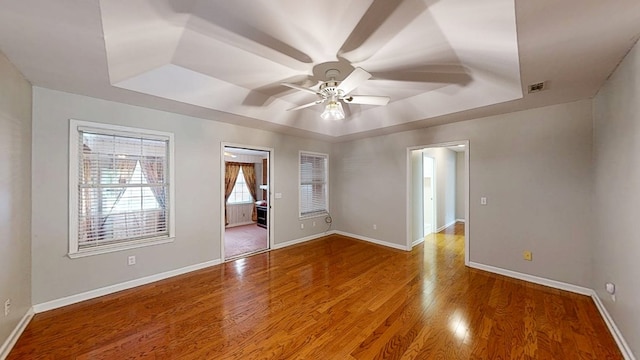 412 Darlington Cir, Dothan, AL 36301 - empty room with a raised ceiling, ceiling fan, wood finished floors, and baseboards