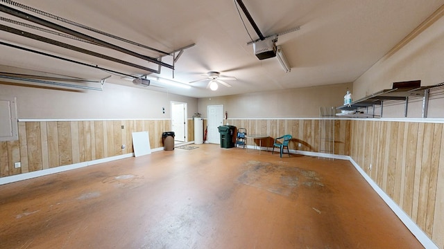 412 Darlington Cir, Dothan, AL 36301 - garage with wooden walls, a garage door opener, ceiling fan, and baseboards