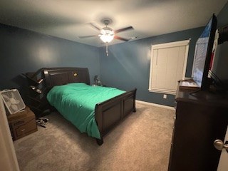 bedroom featuring light carpet and ceiling fan