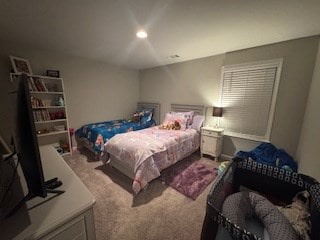 bedroom featuring light carpet