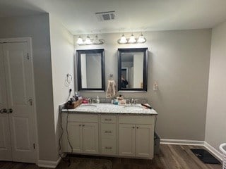 bathroom featuring hardwood / wood-style flooring and vanity