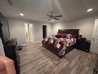 bedroom with hardwood / wood-style floors and ceiling fan