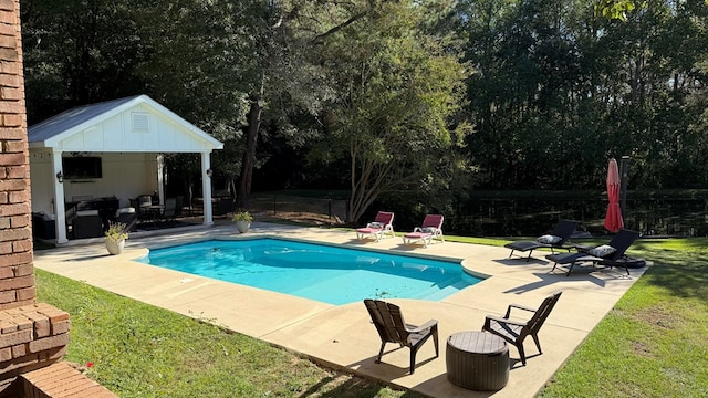 view of pool featuring a patio area and a lawn