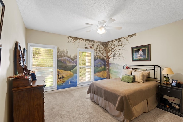 bedroom with multiple windows, ceiling fan, and a textured ceiling