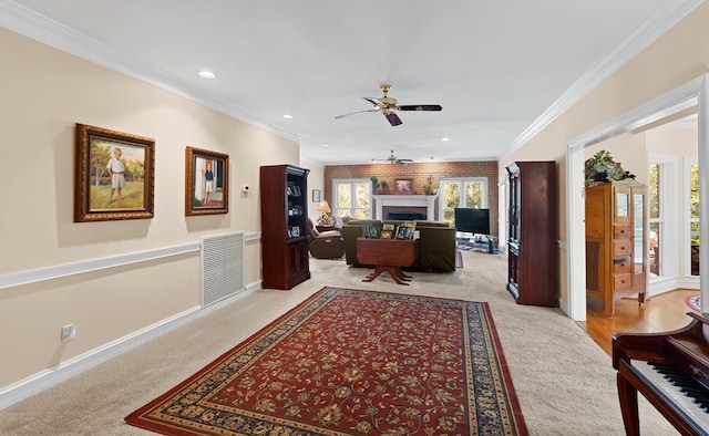 carpeted home office featuring ceiling fan and crown molding