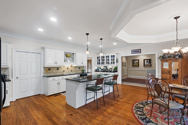 kitchen with a center island, wood-type flooring, and white cabinetry