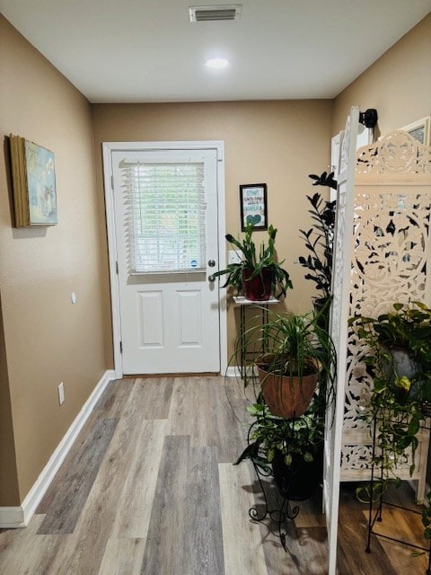 doorway with wood-type flooring