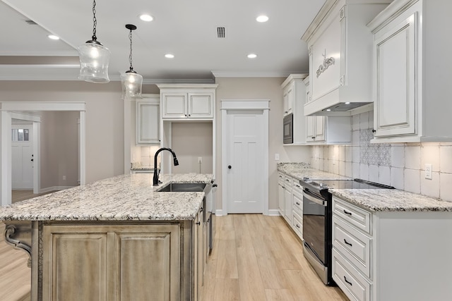 kitchen featuring black appliances, a large island, white cabinetry, and hanging light fixtures