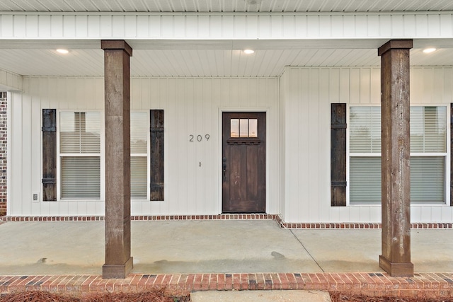 view of exterior entry with covered porch