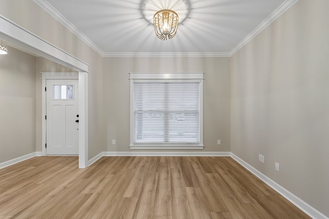 entrance foyer with a healthy amount of sunlight, light wood-type flooring, and a notable chandelier